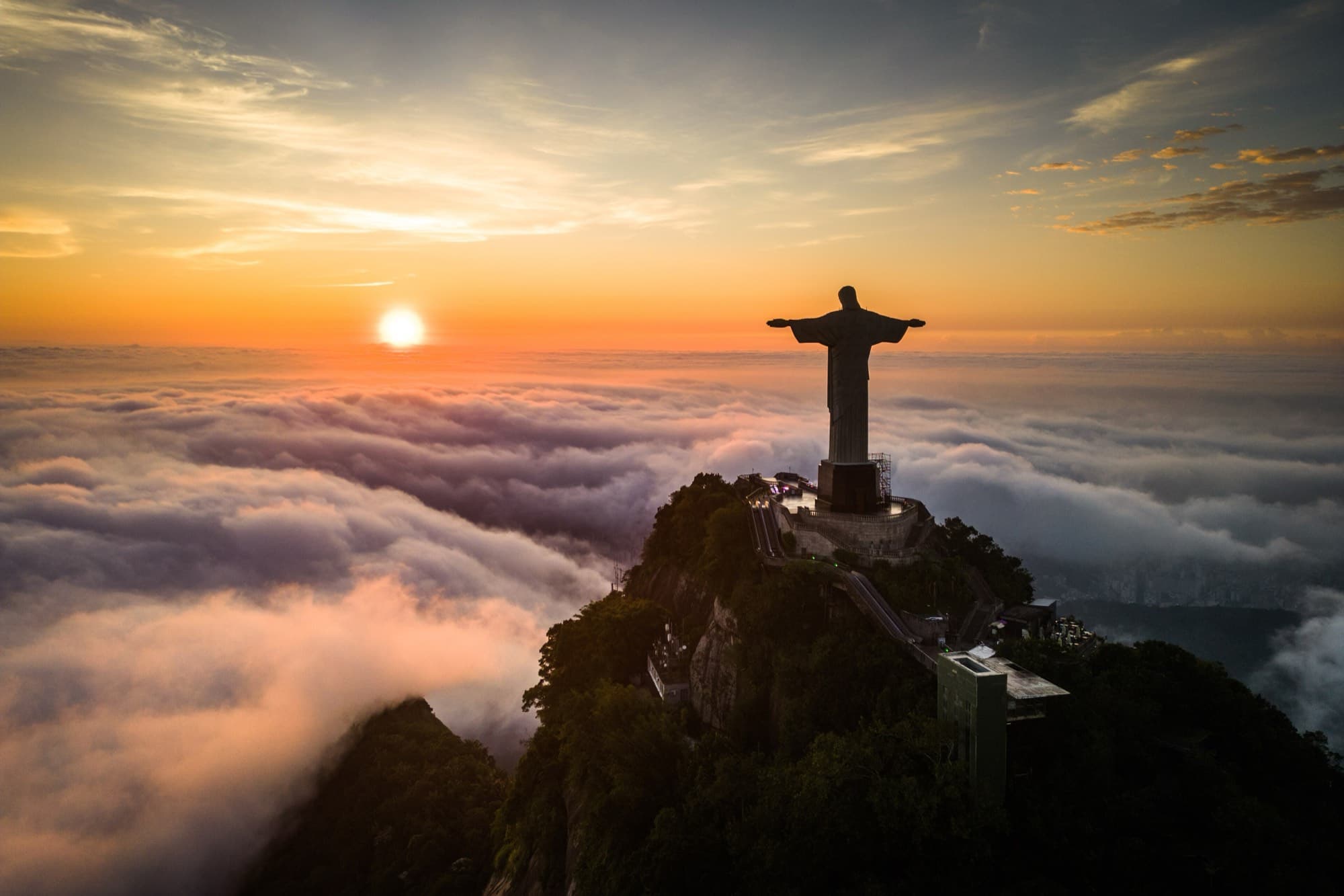 Christ the Redeemer above a sea of cloud at first light